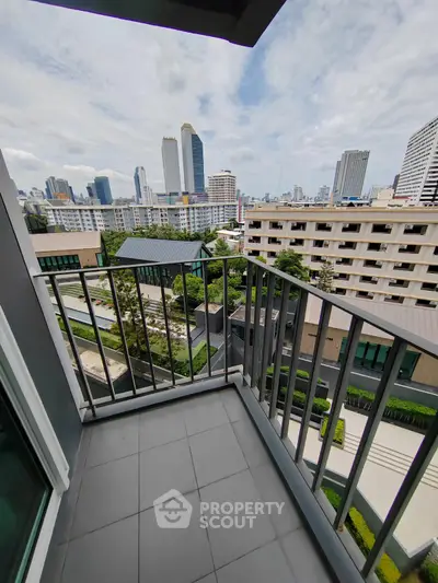 Stunning city view from a modern apartment balcony in a high-rise building.