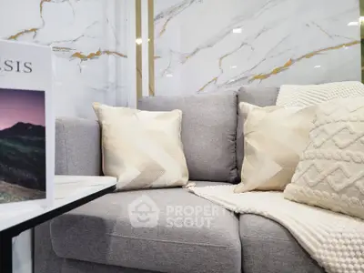 Elegant living room with modern gray sofa and stylish cushions, perfect for cozy relaxation.
