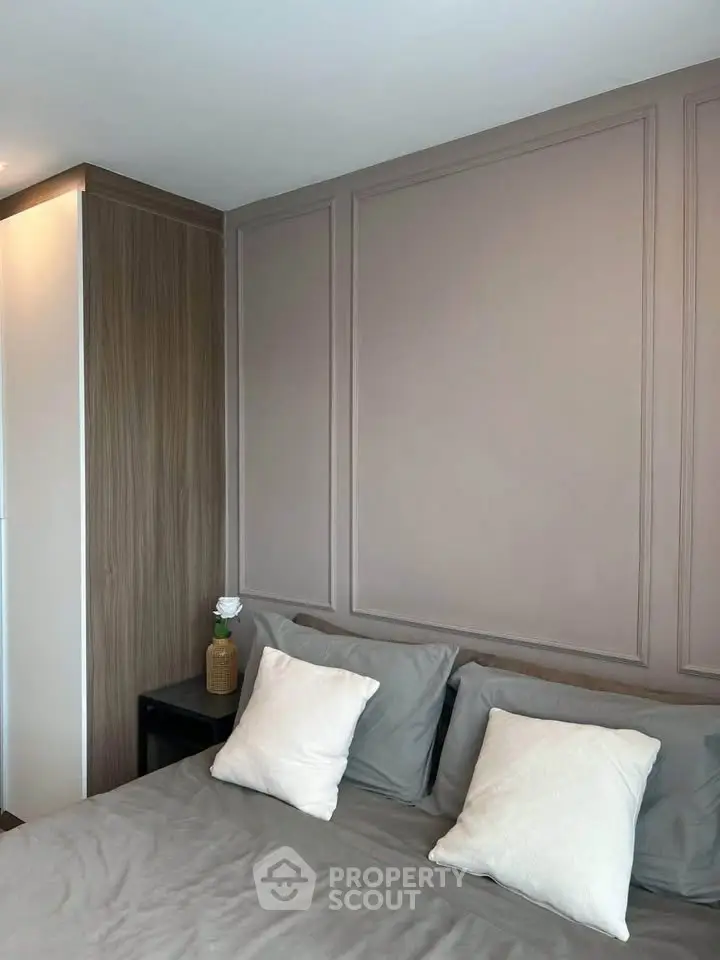 Modern bedroom with elegant paneling and cozy bedding