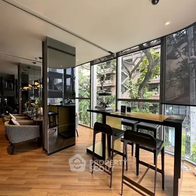 Modern living room with floor-to-ceiling windows and stylish furniture in a corner unit.