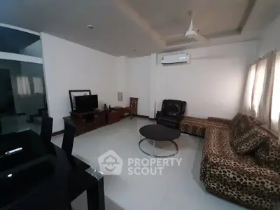 Spacious living room with modern furniture and air conditioning