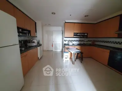 Spacious kitchen with modern cabinetry and ample natural light, perfect for culinary enthusiasts.