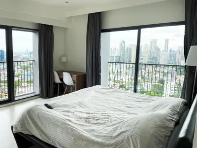 Spacious bedroom with stunning city view and modern decor
