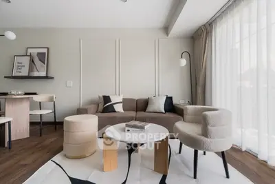 Modern living room with stylish furniture and large windows for natural light.