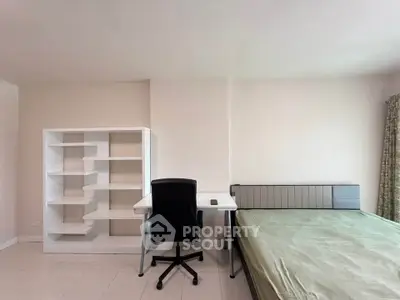 Modern minimalist bedroom with study desk and bookshelf, perfect for a cozy and productive living space.