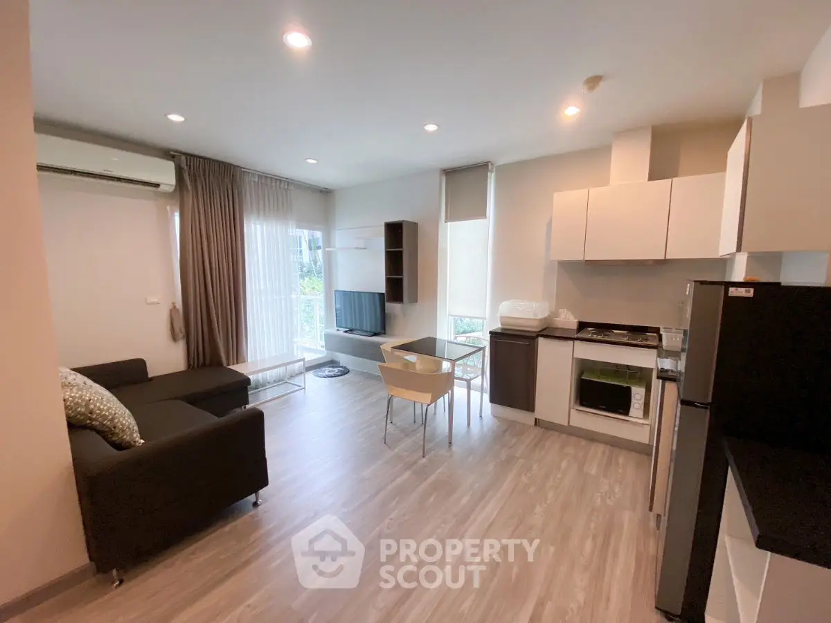 Modern open-plan living room with kitchen in stylish apartment