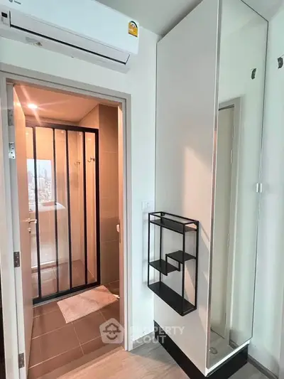 Modern bathroom with sleek design and mirrored storage in a contemporary apartment.