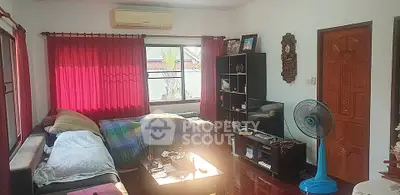 Cozy living room with red curtains, air conditioning, and modern furniture.