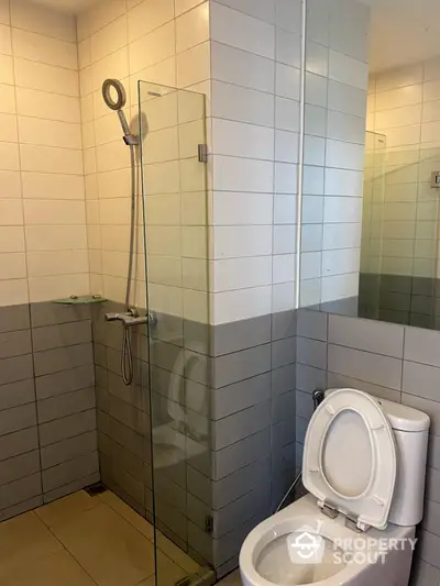 Modern bathroom with glass shower and tiled walls