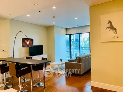 Modern living room with stylish decor and open layout, featuring a cozy seating area and elegant lighting.