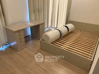 Modern bedroom with wooden flooring and minimalist furniture