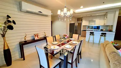 Elegant dining area with modern kitchen in open layout apartment
