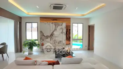 Luxurious living room with modern decor and pool view, featuring elegant lighting and stylish furniture.