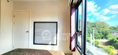 Bright bedroom with large window and scenic view