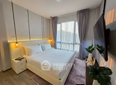 Modern bedroom with elegant decor and large window for natural light