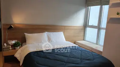 Cozy bedroom with large window and stylish decor