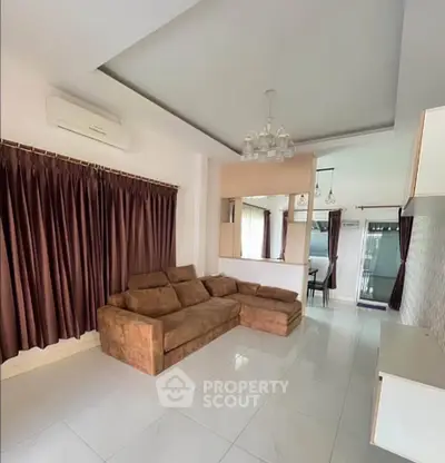 Spacious living room with modern brown sofa and elegant curtains