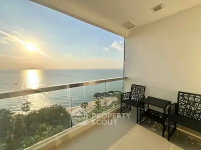 Stunning beachfront balcony with panoramic ocean view and elegant seating area.