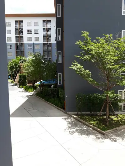 Modern apartment complex with lush greenery and spacious walkways