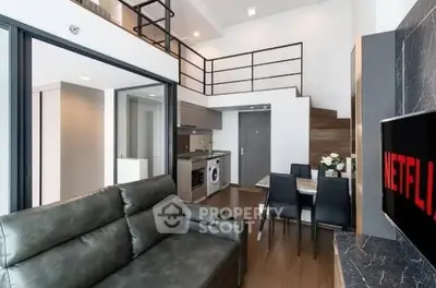 Modern loft apartment with open layout, featuring a cozy living area and stylish kitchen.