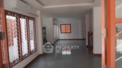 Spacious open-plan living area with large windows and modern finishes