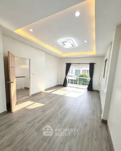 Spacious modern living room with elegant lighting and large windows for natural light.