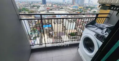 High-rise balcony with washing machine and stunning cityscape view