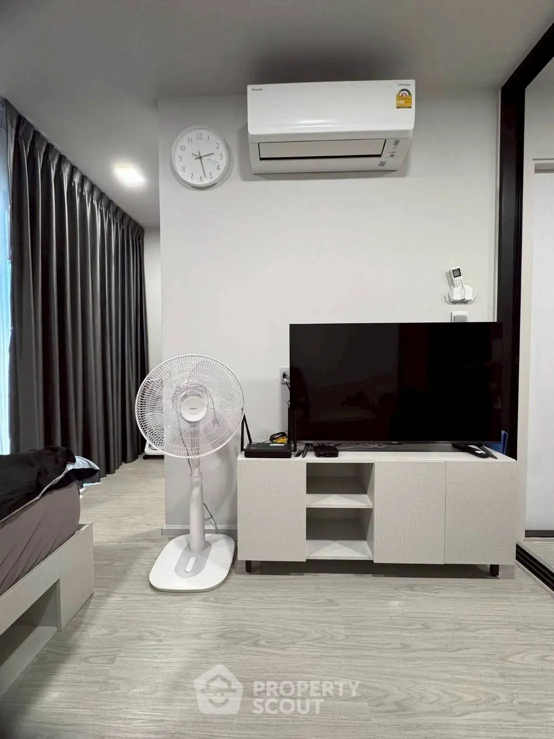 Modern bedroom with air conditioning and sleek TV setup