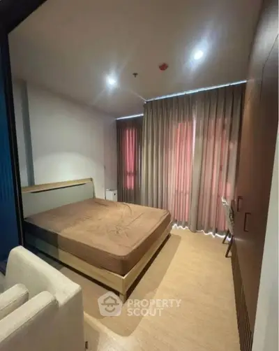 Modern bedroom with cozy lighting and stylish curtains in a contemporary apartment.