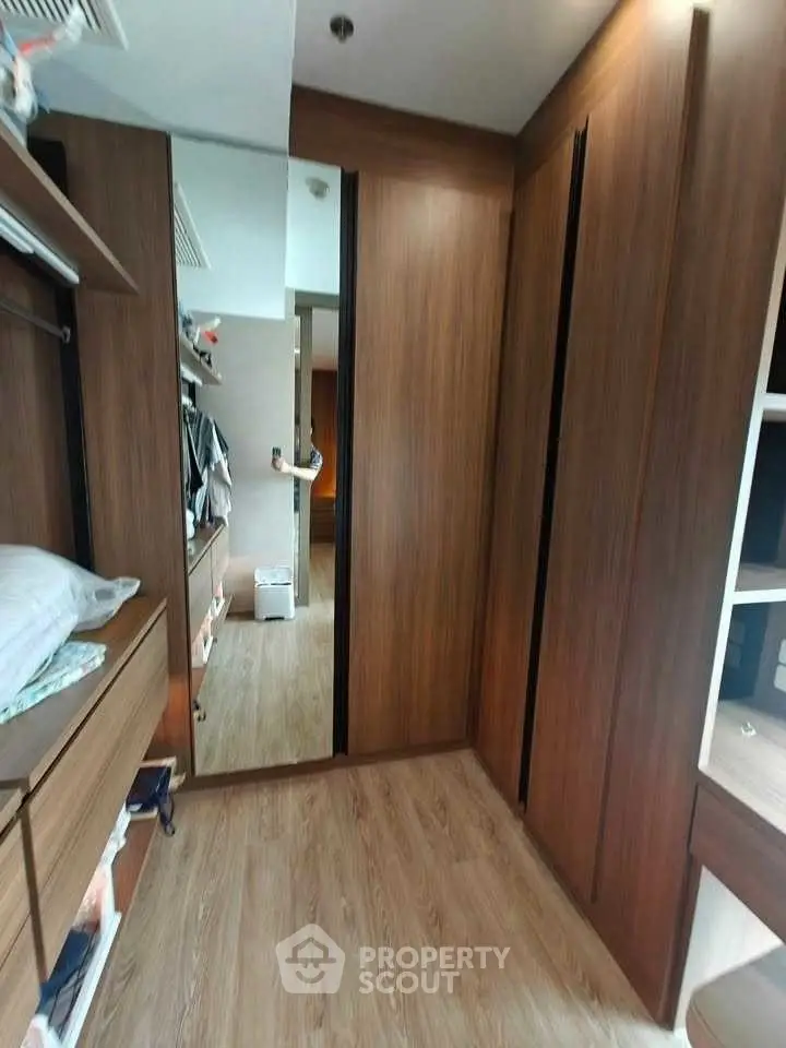Spacious walk-in closet with wooden finishes and ample storage space.