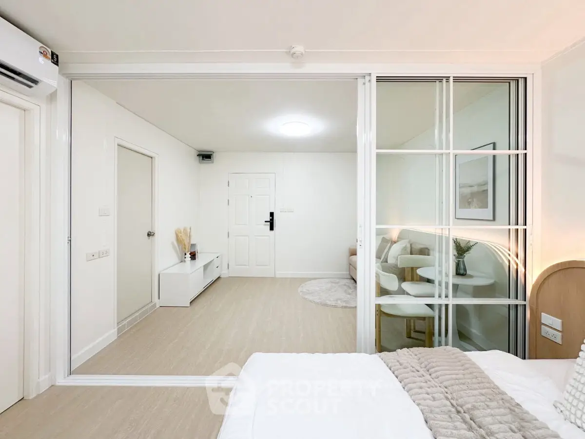 Modern bedroom with sliding glass doors and minimalist decor