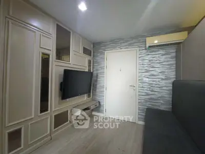 Modern living room with stylish wall paneling and mounted TV, featuring sleek air conditioning unit.