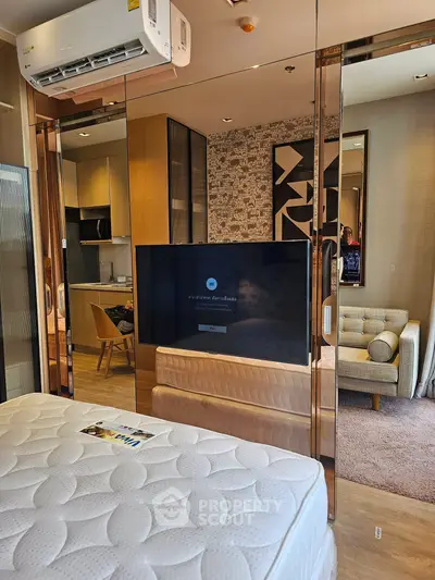 Modern studio apartment with stylish decor and open layout, featuring a cozy living area and contemporary kitchen.