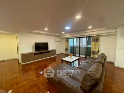 Spacious living room with modern decor and large windows for natural light.