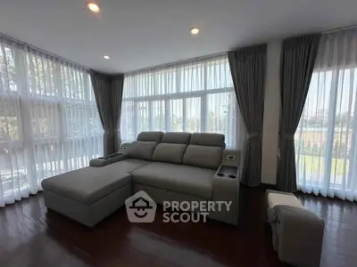 Spacious living room with large windows and modern sectional sofa