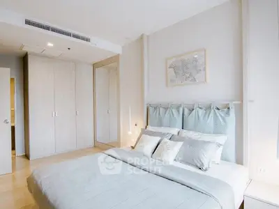 Spacious modern bedroom with elegant decor and ample natural light