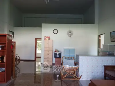 Spacious living room with high ceilings and cozy furniture, perfect for relaxation.