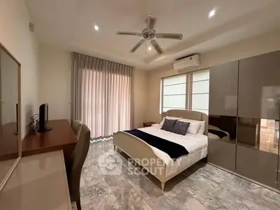Spacious bedroom with modern furnishings and natural light
