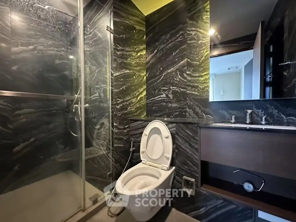 Luxurious modern bathroom with sleek marble walls and glass shower enclosure