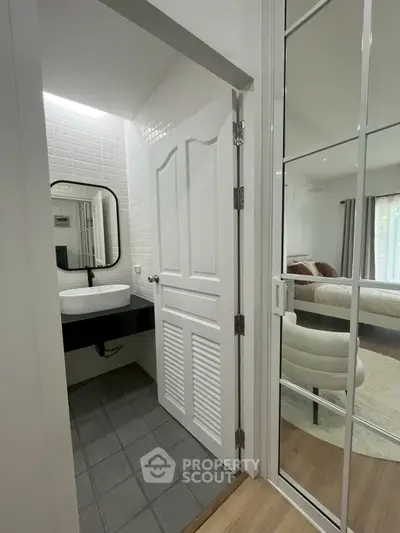 Modern bathroom with sleek design and adjacent bedroom view