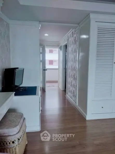 Charming hallway with elegant decor and wooden flooring in a cozy apartment.