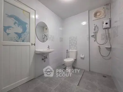 Modern bathroom with dolphin-themed decor and sleek fixtures.