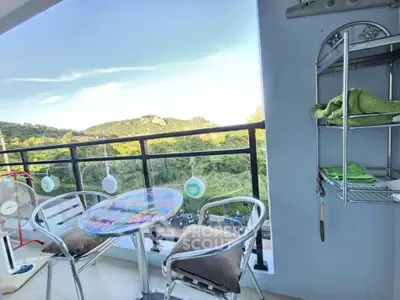 Charming balcony with scenic view and cozy seating area, perfect for relaxation.