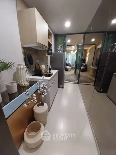 Modern kitchen with sleek design and open layout leading to a stylish living area.