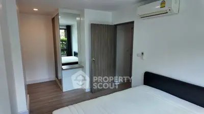 Modern bedroom with air conditioning and mirrored wardrobe in a stylish apartment.