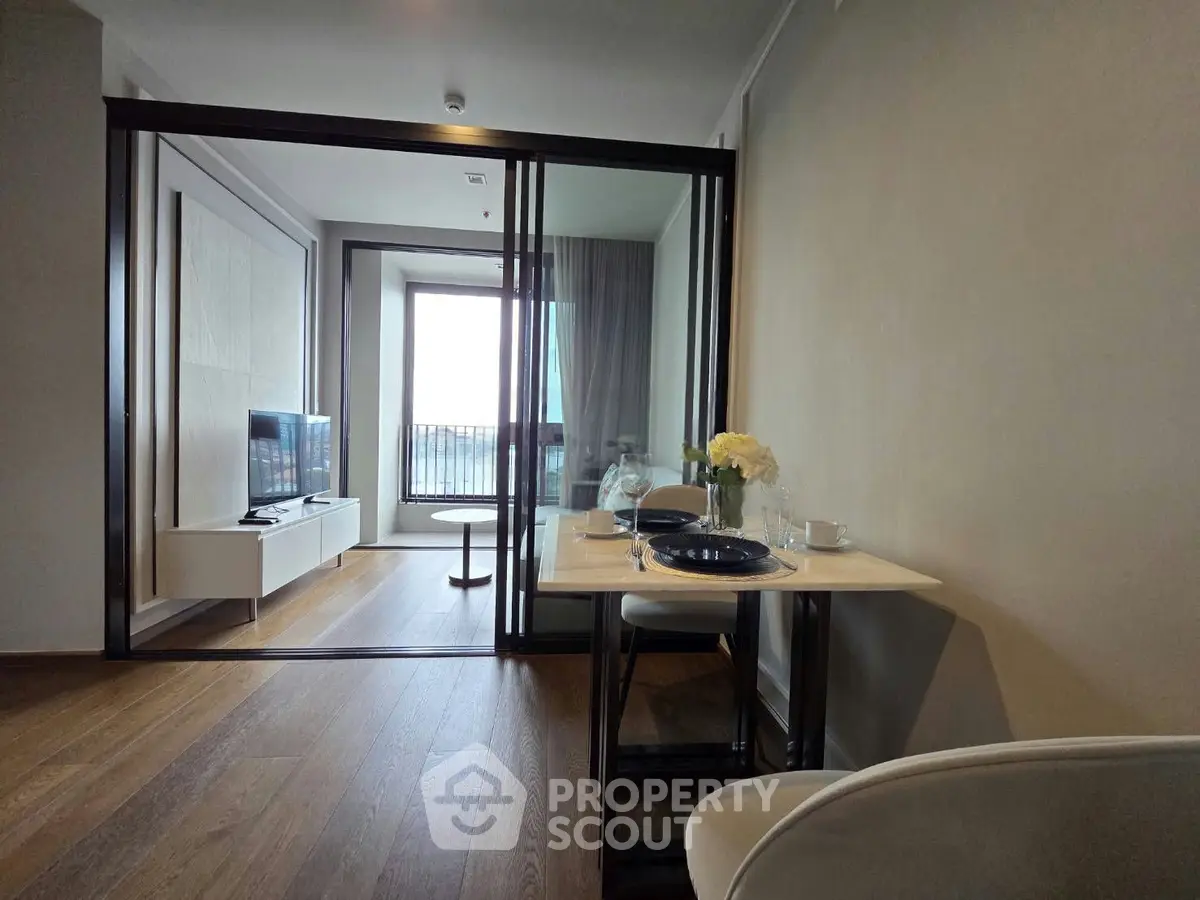 Modern living room with glass partition and balcony view