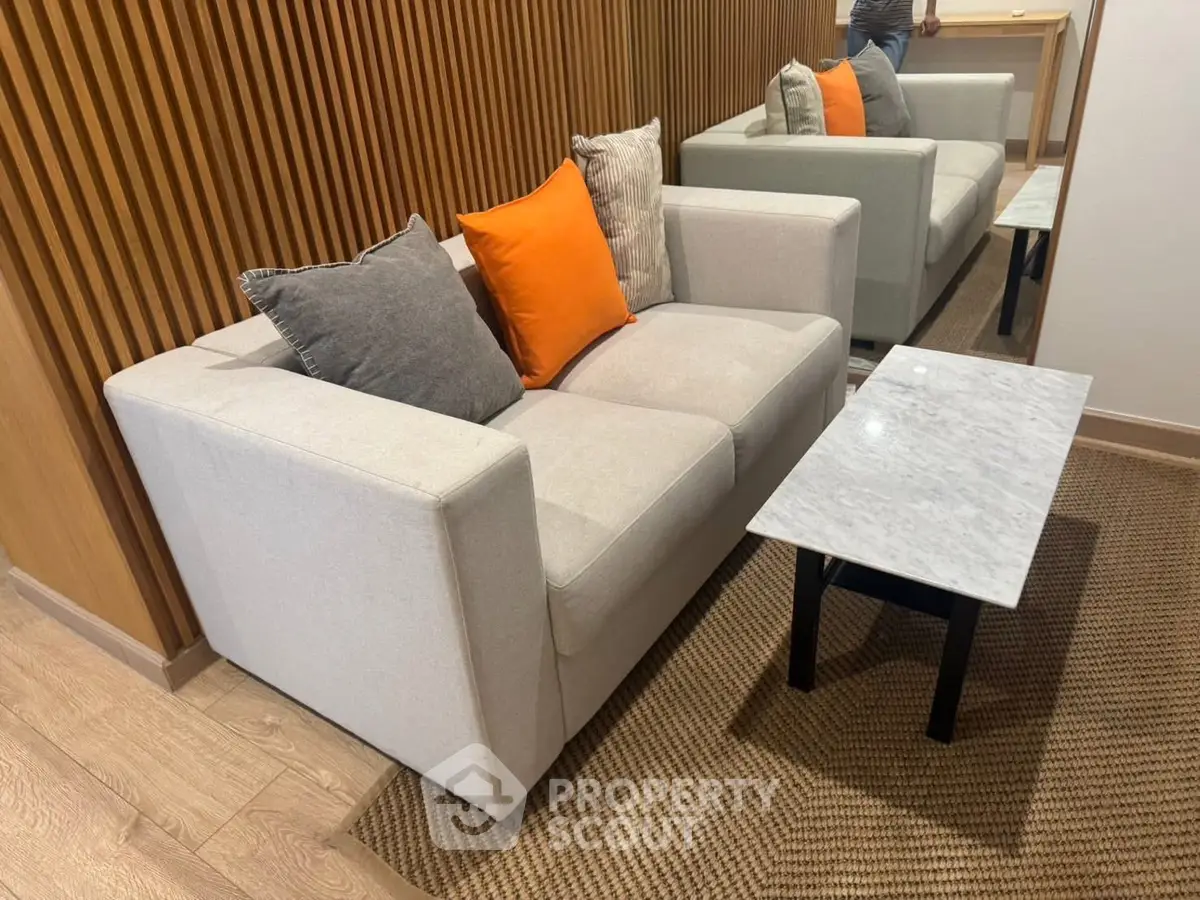 Modern living room with stylish sofa and marble coffee table