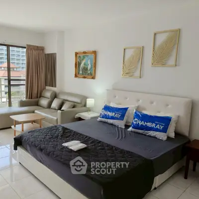 Spacious bedroom with modern decor and balcony view in luxury apartment