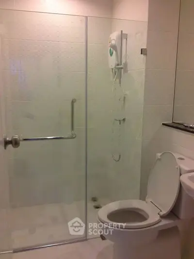 Modern bathroom with glass shower enclosure and sleek fixtures