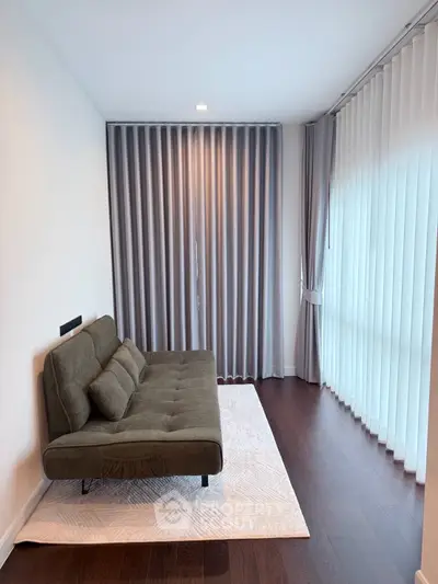 Modern living room with stylish sofa and floor-to-ceiling curtains